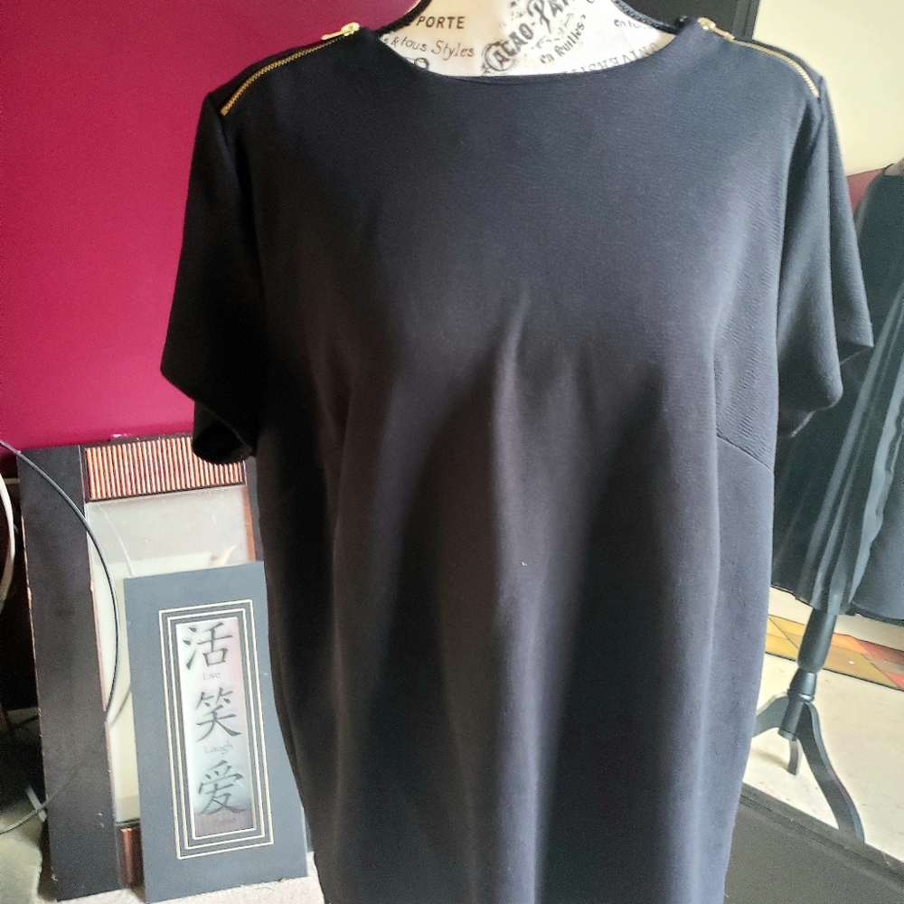 Cute top with zipper shoulders and pleated back.